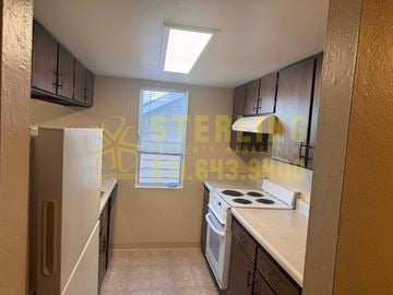 Monterey apartment for rent - A kitchen with a stove top oven and a window with blinds.