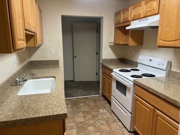Monterey apartment for rent - a kitchen with a white stove and a sink