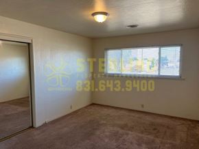Salinas apartment for rent - A room with a carpeted floor and a window with blinds.
