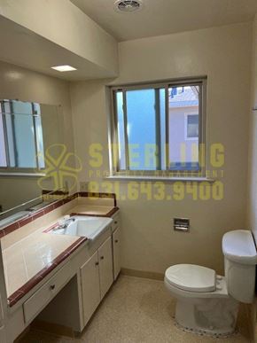 Salinas apartment for rent - A bathroom with a toilet, sink, and mirror.