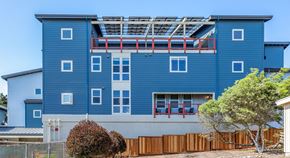 Marina apartment for rent - a blue building with a balcony on top of it