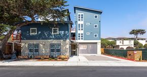 Marina apartment for rent - a blue and white house with a tree in front of it