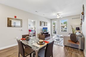 Olathe apartment for rent - A dining room with a glass table and chairs.