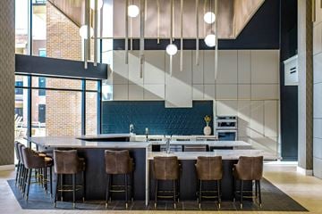 Overland Park apartment for rent - barstools around a counter in an indoor kitchen