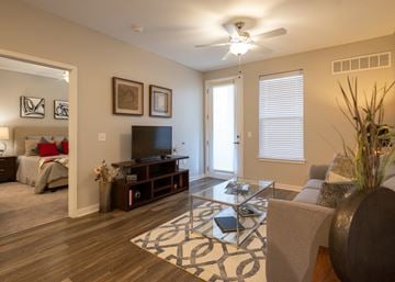 Olathe apartment for rent - a living room with a couch and a coffee table and a television