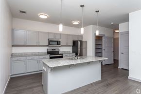 Fayetteville apartment for rent - A modern kitchen with a granite countertop and stainless steel appliances.