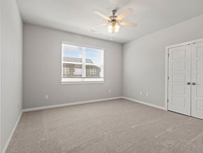 Springdale townhouse for rent - an empty room with a ceiling fan and a window at Hillcrest Village, Springdale, AR 72762