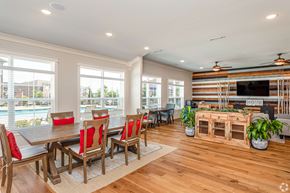 Rogers townhouse for rent - A dining room with a wooden table and chairs.