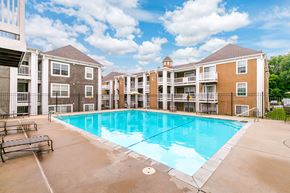 Liberty apartment for rent - A large swimming pool in front of apartment buildings.