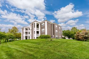 Liberty apartment for rent - A large apartment complex with a green lawn in front.