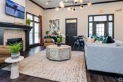 Overland Park townhouse for rent - A living room with a fireplace and a grey couch.