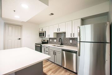 Kansas City apartment for rent - A kitchen with a white counter top and stainless steel appliances.