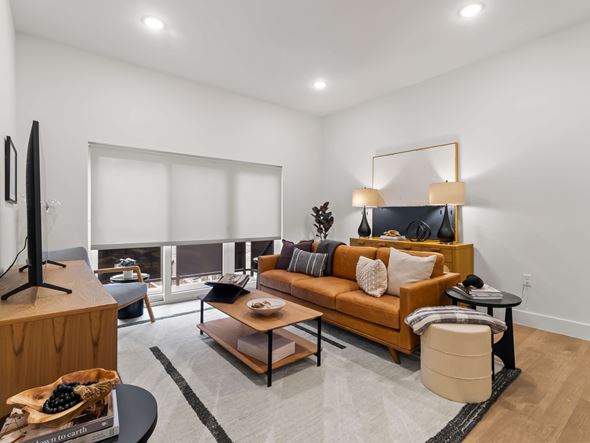 Bentonville apartment for rent - A Living Room With a Brown Sofa at G at Market Apartments, Bentonville, 72712