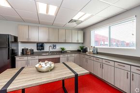 Des Moines apartment for rent - a kitchen with wooden cabinets and a table with a bowl of eggs