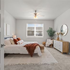 Springdale townhouse for rent - a bedroom with a bed and a ceiling fan at Hillcrest Village, Springdale, AR
