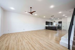 Bentonville apartment for rent - A room with a ceiling fan and wooden flooring.
