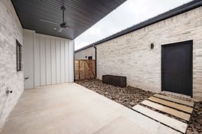 Bentonville apartment for rent - A modern house with a black door and a black ceiling fan.