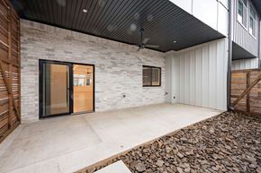 Bentonville apartment for rent - A modern house with a black ceiling fan and a glass door.
