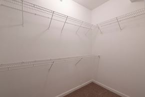 Lenexa apartment for rent - a walk in closet with white racks