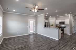 Rogers townhouse for rent - A spacious kitchen and living room with a ceiling fan and recessed lighting.