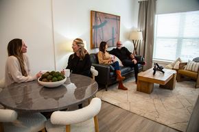 Castle Rock apartment for rent - Three people are sitting around a table with a bowl of fruit in the middle.