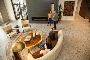 Castle Rock apartment for rent - A group of people are sitting around a wooden coffee table in a spacious room.