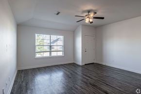 Springdale triplex for rent - A room with a ceiling fan and a window with blinds.