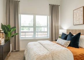 Castle Rock apartment for rent - A bedroom with a large bed and a window with curtains.