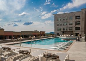 Castle Rock apartment for rent - A pool with sun loungers and a building in the background.