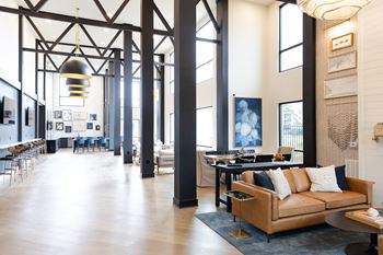 A large room with a couch and a table.