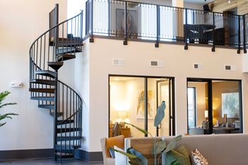 A living room with a spiral staircase.
