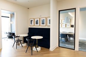Mcdonough apartment for rent - A modern dining room with a black sofa and a white table at The Crest at South Point Apartments, Davenport