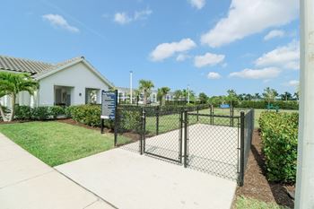 A fenced in yard with a house in the background