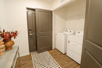 A small laundry room with a washer and dryer