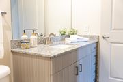 Acworth apartment for rent - A bathroom with a marble countertop and a toilet.