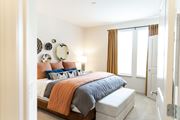 Acworth apartment for rent - A bedroom with a bed, pillows, and a mirror on the wall.