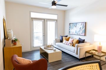 Acworth apartment for rent - Living room with balcony access and modern furnishings at The Crest at Acworth Apartments, Acworth