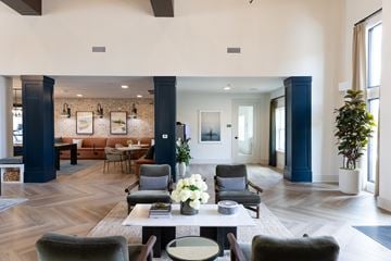 Oakwood apartment for rent - A large, modern living room with a long table and chairs.