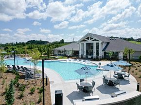 Oakwood apartment for rent - A large outdoor swimming pool with a building in the background. at The Crest at Oakwood Apartments, Oakwood , Georgia
