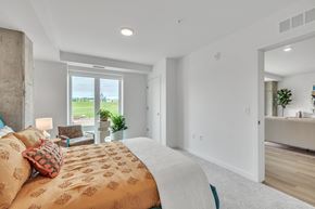 St. Paul apartment for rent - a bedroom with a bed and a living room with a window