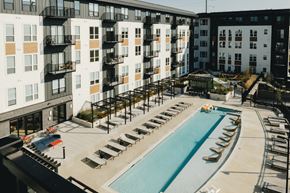 Madison apartment for rent - an aerial view of a swimming pool in front of an apartment building