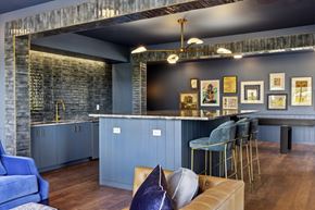 St. Paul apartment for rent - a kitchen and living room with blue cabinets and a bar