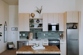 Duluth apartment for rent - a kitchen with white cabinets and stainless steel appliances