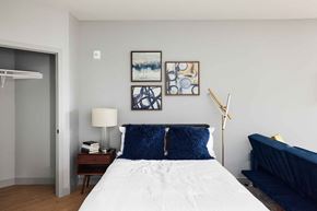 St Paul apartment for rent - a bedroom with a bed and paintings on the wall