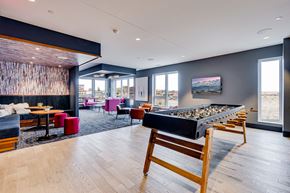 St Paul apartment for rent - a game room with a bar and a seating area with tables and chairs