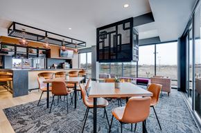 St Paul apartment for rent - a dining area with tables and chairs and a bar