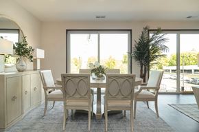 Wayzata apartment for rent - a dining room with a table and chairs and a large window