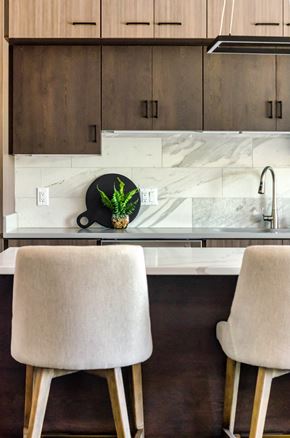 Wayzata apartment for rent - a kitchen counter with two chairs and a sink