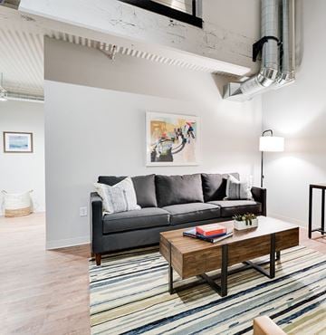 St. Paul apartment for rent - A living room with a grey couch and a wooden coffee table.