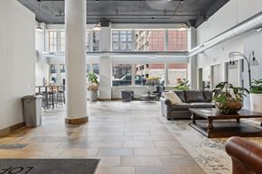 St. Paul apartment for rent - A spacious lobby with a large rug and a coffee table.